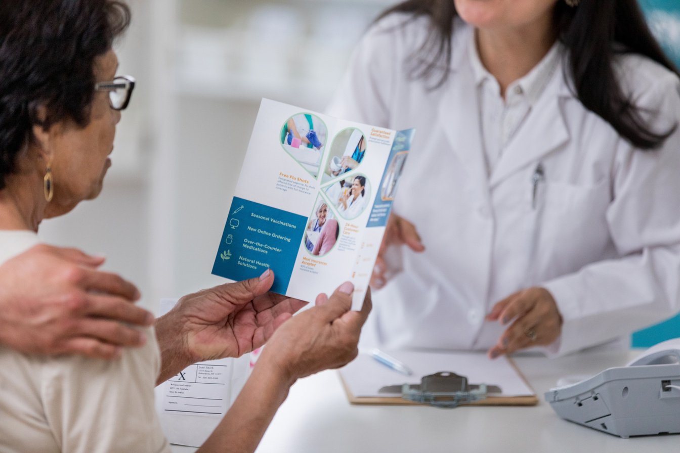 Senior woman examines pharmacy brochure